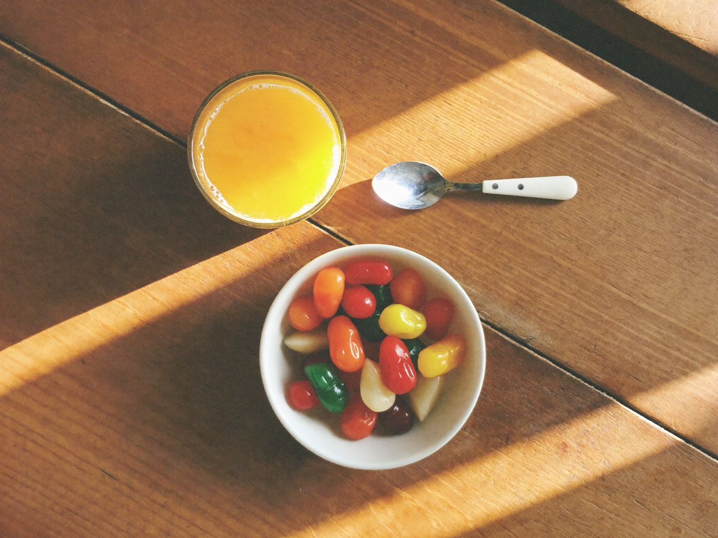 A bowl of colorful gummy vitamins on a kitchen table as part of a morning routine